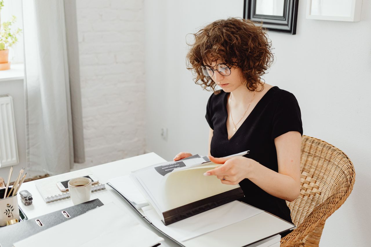 Employee reviewing invoices and digital approval workflows